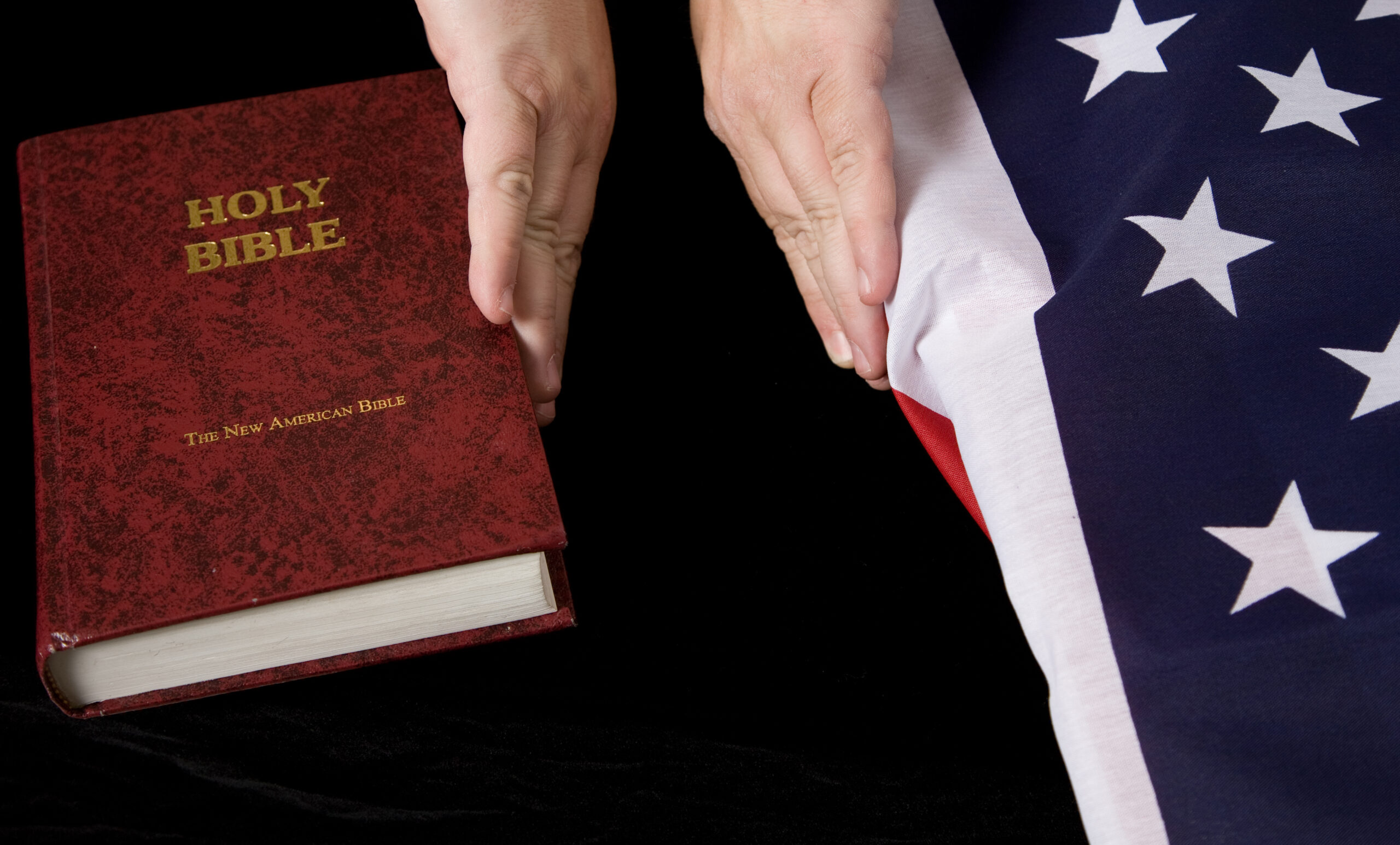 Bible held away from Flag
